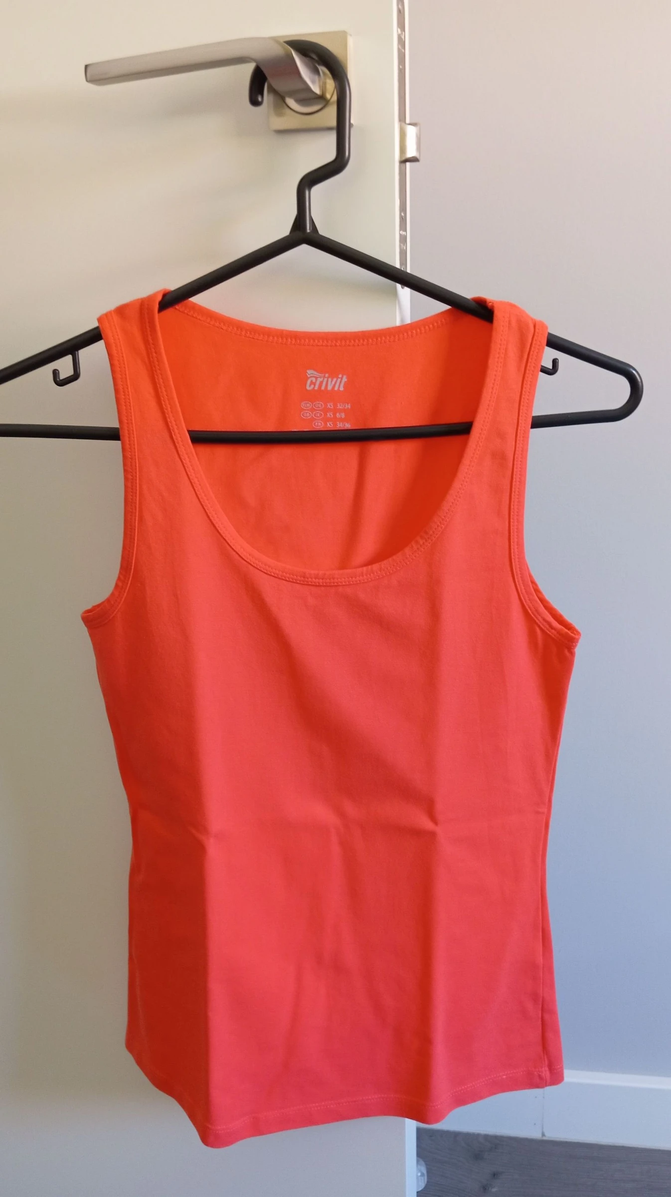 Camiseta sin mangas naranja. Talla XS.